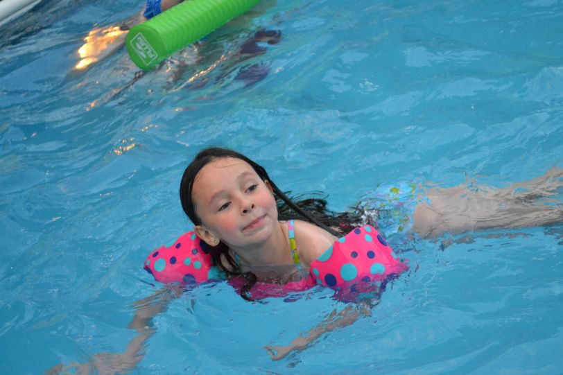 Water princess Zoe enjoys the warm pool water.